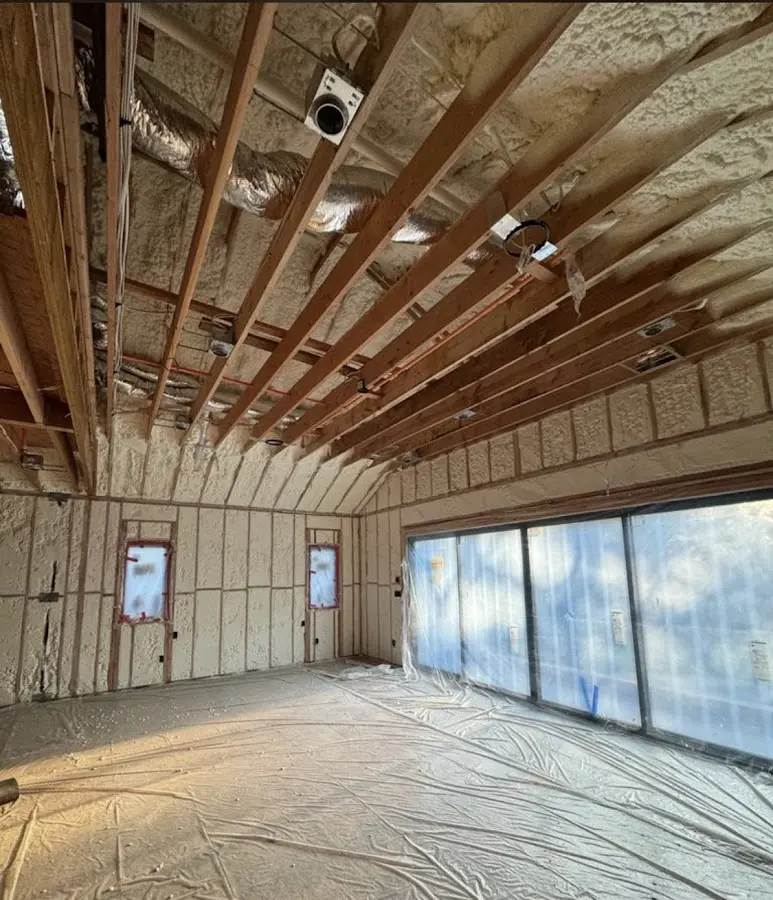Interior walls and ceiling insulated with spray foam during new construction in Hutchinson